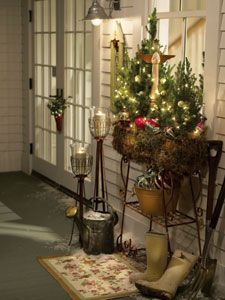 a christmas tree sitting on top of a potted planter next to a window