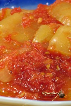 a close up of a bowl of food with pineapples on top and red sauce in the middle