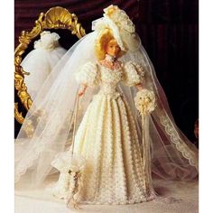 a barbie doll dressed in a wedding gown and veil with a dog on her lap