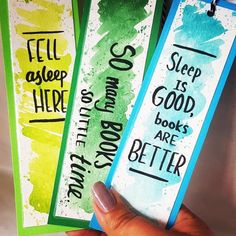 hand holding three bookmarks that say sleep is good, books are better