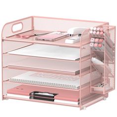 the pink desk organizer is organized with pens and notebooks