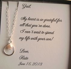 a white card with a silver necklace in it and a poem written on the back