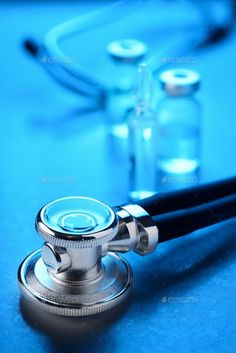 a medical stethoscope on a blue background - stock photo - images