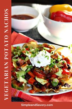 an image of mexican food on a plate with salsa and sour cream in the background