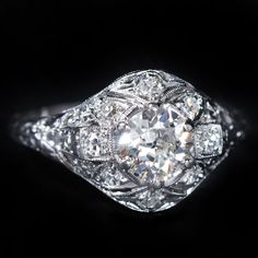 an old - fashioned diamond ring with filigrees on the shoulders and sides