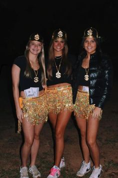 three women in costumes posing for the camera