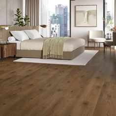 a bedroom with hardwood floors and white walls