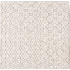 a white rug with an intricate design on the front and back side, in shades of beige