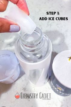 someone is adding ice cubes to a cup with the lid down and one hand on top of it