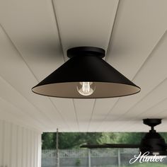 a ceiling fan and light fixture in an outdoor room