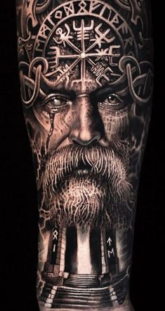 a man's arm with tattoos on it and an image of the face of jesus