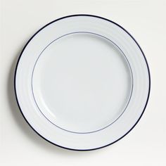 an empty white plate with blue trim on it