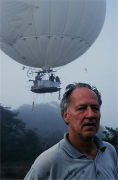 a man standing in front of a hot air balloon