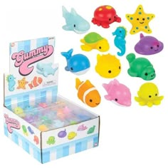 a box filled with lots of different colored plastic toy fish next to it's packaging