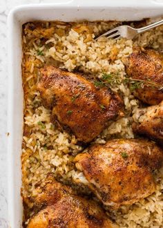 chicken and rice in a casserole dish with a fork