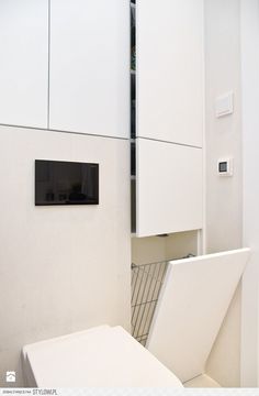 a white toilet sitting in a bathroom next to a cabinet