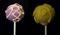 three different colored lollipops with icing on them