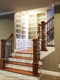 the stairs are made of wood and have metal handrails, along with built - in bookcases