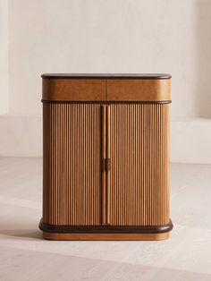 a wooden cabinet sitting on top of a white floor