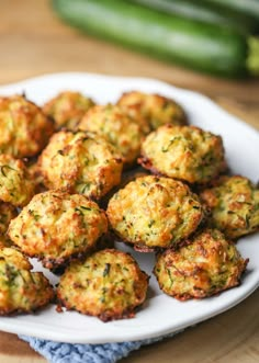 cheesy baked zucchini bites on a white plate with text overlay