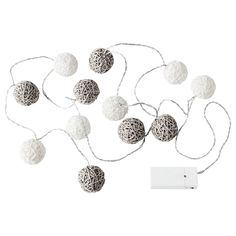 white balls and string lights on a white background