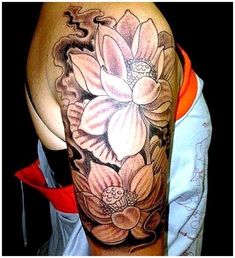 a woman's half sleeve with flowers on her left arm and the other half