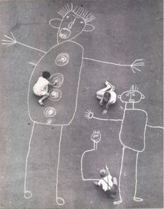 two people standing in front of a chalk drawing on the ground next to each other