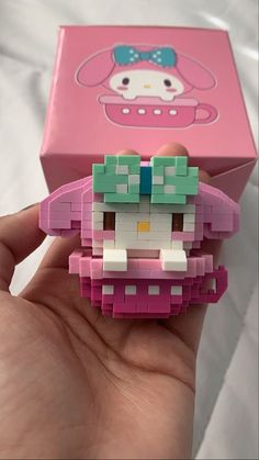 someone is holding up a hello kitty toy in their hand and it looks like they have been made out of legos