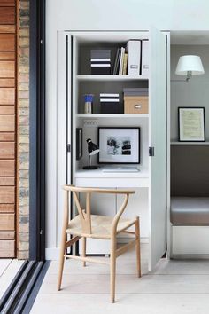 a chair sitting in front of a book shelf filled with books