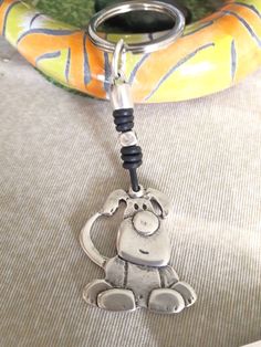 a keychain with a monkey on it is sitting next to a banana shaped object