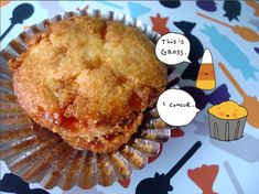 a muffin sitting on top of a cupcake wrapper next to a candy cone