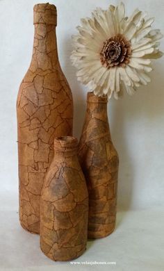 three vases and a flower on a white background