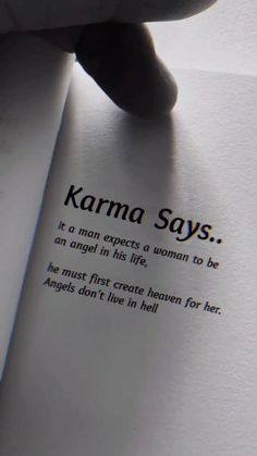 someone is holding an open book with the text karma says it's man experts a woman to be an angel in his life