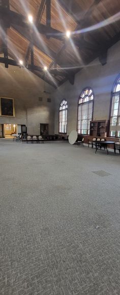 an empty room with benches and windows in the ceiling is seen from across the room