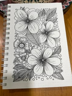 a notebook with flowers drawn on it