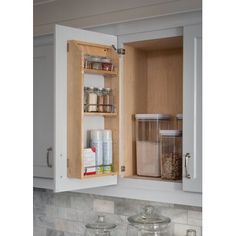 an open medicine cabinet in a kitchen