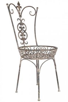 a metal chair with ornate designs on the armrests and back, against a white background