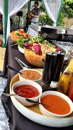 a table topped with lots of different types of food and condiments on top of it