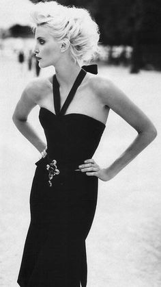 black and white photograph of a woman in a strapless dress with her hands on her hips