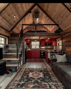 a living room filled with furniture next to a kitchen and dining area on top of a wooden floor