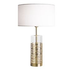 a table lamp with a white shade on the top and gold trimming around it