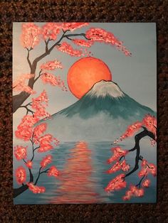 a painting of a sunset over a mountain with cherry blossoms in the foreground and water below