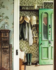 a green door with hats hanging on it