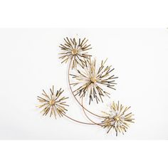 three metal flowers on a white background