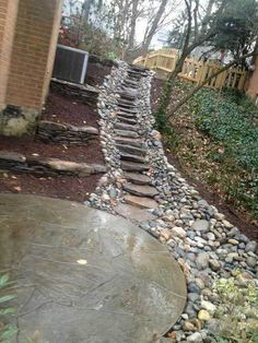 a stone path in the middle of a yard