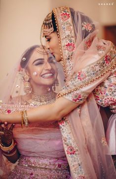 the bride and groom are hugging each other