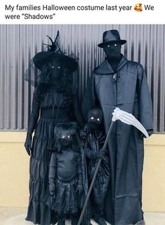 three people dressed up in costumes standing next to each other with black faces on them