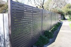 a fence that is made out of wood and has vertical slats on the sides