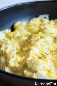 a close up of a plate of food with eggs and gravy on it