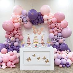 a first birthday party with balloons and cake